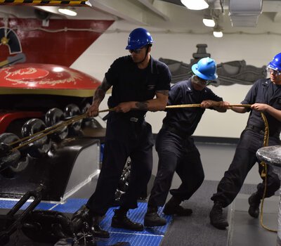 Deck Department Sailors heaving a line on the U.S. Navy
