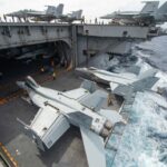 Sailors direct F/A-18E Super Hornets, with Strike Fighter Squadron (VFA) 14, onto an aircraft elevator aboard the Nimitz-class aircraft carrier USS John C. Stennis (CVN 74)
