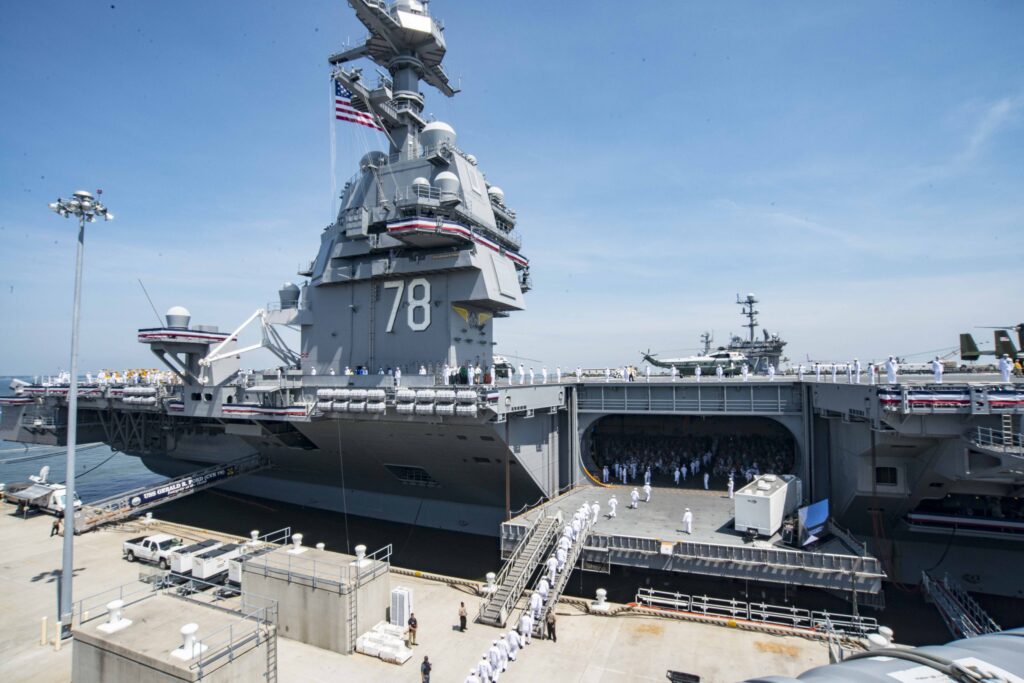 Sailors man the rails of the aircraft carrier USS Gerald R. Ford (CVN 78